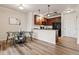 Modern kitchen and dining area with cherry cabinets, stainless appliances, and a breakfast bar at 1062 Rockhurst Dr # 401, Highlands Ranch, CO 80129