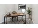 Close-up of home office featuring a modern desk, a woven chair, and a decorative plant at 1062 Rockhurst Dr # 401, Highlands Ranch, CO 80129