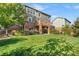 Green backyard featuring a deck, stone accents, and lush landscaping at 6310 S Ider St, Aurora, CO 80016