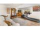 A spacious basement with a wooden cabinet, a comfortable couch, and workout equipment at 6310 S Ider St, Aurora, CO 80016