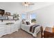 Well-lit bedroom features a dresser, vintage desk, and bright windows at 6310 S Ider St, Aurora, CO 80016