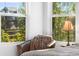 Cozy bedroom chair next to a bright window with natural light and outside views at 6310 S Ider St, Aurora, CO 80016