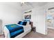 Cozy bedroom featuring a decorative headboard and nearby closet entry at 6310 S Ider St, Aurora, CO 80016