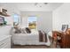 Sunlit bedroom with bright windows, dresser, and vintage desk at 6310 S Ider St, Aurora, CO 80016