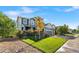 Charming two-story home featuring a well-manicured lawn, mature tree, and an attached two-car garage at 6310 S Ider St, Aurora, CO 80016