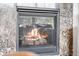 Close-up of a cozy fireplace with a decorative stone surround, radiating warmth and ambiance at 6310 S Ider St, Aurora, CO 80016