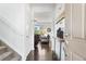 Bright entryway with hardwood floors, staircase, and a glimpse of the living room at 6310 S Ider St, Aurora, CO 80016