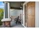 Charming front porch with seating area, perfect for enjoying the outdoors by the entry door at 6310 S Ider St, Aurora, CO 80016