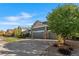 Spacious three-car garage and driveway, framed by mature landscaping on a sunny day at 6310 S Ider St, Aurora, CO 80016