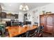 Open-concept kitchen features stainless appliances, granite countertops, dark cabinets, and island seating at 6310 S Ider St, Aurora, CO 80016