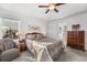 Main bedroom with a ceiling fan, large window, and ensuite bathroom at 6310 S Ider St, Aurora, CO 80016