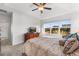 Bright main bedroom with carpet, tray ceiling, and large windows offering neighborhood views at 6310 S Ider St, Aurora, CO 80016