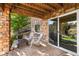 Covered stone patio with outdoor seating and a view of the backyard, perfect for relaxation and entertainment at 6310 S Ider St, Aurora, CO 80016