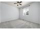 Empty bedroom with neutral gray carpeting, a window, and a ceiling fan at 7814 Grady Cir, Castle Rock, CO 80108