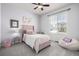 Cozy bedroom with a soft pink theme, a window view, and comfortable furniture at 7814 Grady Cir, Castle Rock, CO 80108