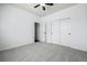 Empty bedroom featuring neutral gray carpeting, a ceiling fan, a window, and a closet at 7814 Grady Cir, Castle Rock, CO 80108