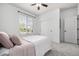 Bright and airy bedroom featuring soft pink accents, a large window, and closet at 7814 Grady Cir, Castle Rock, CO 80108