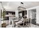 Stylish dining area adjacent to the kitchen with a modern light fixture and seating for six at 7814 Grady Cir, Castle Rock, CO 80108
