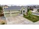 Charming green home with a well-kept lawn, three-car garage, stone accents and a spacious driveway at 7814 Grady Cir, Castle Rock, CO 80108