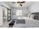 Beautiful main bedroom featuring a ceiling fan, an upholstered headboard, and an ensuite bathroom with tub at 7814 Grady Cir, Castle Rock, CO 80108