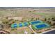 Aerial view of well-maintained community tennis courts with blue and green surfaces and surrounding landscaping at 7814 Grady Cir, Castle Rock, CO 80108