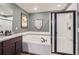 Modern bathroom featuring soaking tub and glass-enclosed shower at 14799 Longhorn Dr, Mead, CO 80542