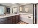 Modern bathroom featuring double vanity with granite countertop, soaking tub, and glass-enclosed shower at 14799 Longhorn Dr, Mead, CO 80542