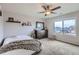 Comfortable bedroom with neutral decor, ceiling fan, and a window overlooking the neighborhood at 14799 Longhorn Dr, Mead, CO 80542