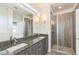 Bathroom with granite countertops, double sinks, and a shower at 2692 Front View Cres, Denver, CO 80211