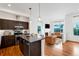 Open concept kitchen with island and stainless steel appliances at 2692 Front View Cres, Denver, CO 80211