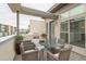 Spacious patio with glass-top table and wicker chairs, offering city views at 2692 Front View Cres, Denver, CO 80211