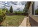 Large backyard with grass and perimeter fence, and access to a covered porch at 1099 Wheeling St, Aurora, CO 80011