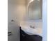 Clean bathroom with classic white tile, chrome fixtures and a dark vanity at 1099 Wheeling St, Aurora, CO 80011