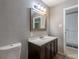 Bathroom has a toilet, vanity, and doorway to the bedroom at 1099 Wheeling St, Aurora, CO 80011