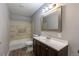 Cozy bathroom has vinyl flooring, vanity with storage, and classic tile surround at 1099 Wheeling St, Aurora, CO 80011