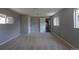 Bedroom with neutral walls and carpet; access to the kitchen and hall provides easy living at 1099 Wheeling St, Aurora, CO 80011