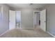 Carpeted bedroom with ensuite and second doorway, freshly painted gray walls and a light bright feel at 1099 Wheeling St, Aurora, CO 80011