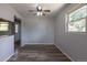 Neutral dining room with wood-look vinyl flooring and a ceiling fan at 1099 Wheeling St, Aurora, CO 80011