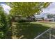 Quaint home with a lush green lawn, mature trees, and inviting front entrance at 1099 Wheeling St, Aurora, CO 80011