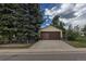 Two-car detached garage featuring brown doors and a concrete driveway at 1099 Wheeling St, Aurora, CO 80011