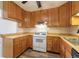 Traditional kitchen with wood cabinets, neutral countertops and appliances, plus durable plank flooring at 1099 Wheeling St, Aurora, CO 80011