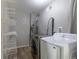 The laundry room has modern washer and dryer and plenty of shelving for storage at 1099 Wheeling St, Aurora, CO 80011