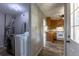 View of the laundry room with modern machines next to the kitchen with wooden cabinets at 1099 Wheeling St, Aurora, CO 80011