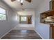 Open-concept living room flows into a kitchen with wood-look vinyl flooring at 1099 Wheeling St, Aurora, CO 80011