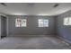 Spacious living room offers plush neutral carpet, light gray paint, and ample natural light at 1099 Wheeling St, Aurora, CO 80011