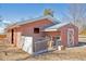 Barn exterior with pink wood and white trim with an open pasture area at 2372 Haskell Way, Watkins, CO 80137