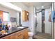 Stylish bathroom with a modern vanity and walk-in shower featuring black and white tiles at 2372 Haskell Way, Watkins, CO 80137