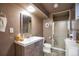 Cozy bathroom with a shower, toilet, sink, mirror, and vanity at 2372 Haskell Way, Watkins, CO 80137