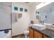 Bathroom featuring modern sink, decorative mirror and tile, and separate tub and shower at 2372 Haskell Way, Watkins, CO 80137