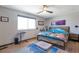 Cozy bedroom with wood floors, ceiling fan, and a bright window for natural light at 2372 Haskell Way, Watkins, CO 80137